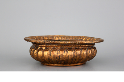 A Flemish brass alms dish, an Italian brass basin and a French brass kettle, all 17th C.